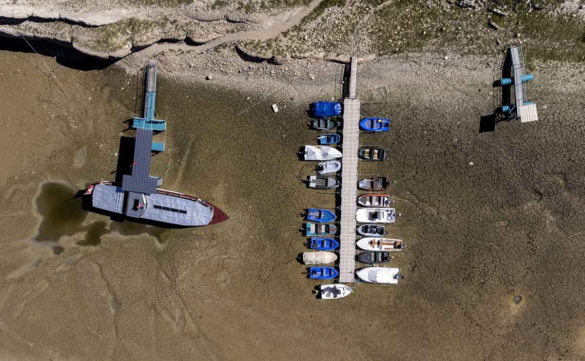 effects of climate change: boats on shallow river